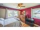 Bedroom featuring hardwood floors, bright walls, and large windows overlooking the greenery at 582 Wimbleton Dr, Raleigh, NC 27609