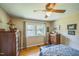Bright bedroom with hardwood floors, neutral paint, large window, and ceiling fan at 582 Wimbleton Dr, Raleigh, NC 27609