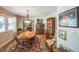 Bright dining room featuring a chandelier, hardwood floors, and a round table with seating for six at 582 Wimbleton Dr, Raleigh, NC 27609