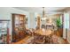 Elegant dining room with hardwood floors, a wooden table, and a decorative china cabinet at 582 Wimbleton Dr, Raleigh, NC 27609