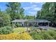 Charming single-story home with a welcoming front porch, lush landscaping, and convenient carport at 582 Wimbleton Dr, Raleigh, NC 27609