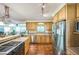 Well-lit kitchen with wooden cabinets, stainless steel appliances, and tile backsplash at 582 Wimbleton Dr, Raleigh, NC 27609