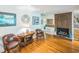 Cozy living room with a brick fireplace, hardwood floors, and comfortable seating at 582 Wimbleton Dr, Raleigh, NC 27609