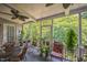 Serene screened-in porch with tiled floor, comfortable seating, and lush green surroundings at 582 Wimbleton Dr, Raleigh, NC 27609
