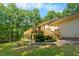A shot of the backyard featuring a spacious deck, mature shade trees and lush landscaping at 5822 Country Lane Dr, Durham, NC 27705