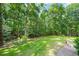 Spacious backyard featuring grass and mature trees at 5822 Country Lane Dr, Durham, NC 27705