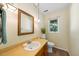 Small bathroom with vanity and sink featuring a gold framed mirror and wood cabinets at 5822 Country Lane Dr, Durham, NC 27705