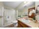 Bathroom featuring a glass enclosed shower, toilet, and vanity with a sink and flower decoration at 5822 Country Lane Dr, Durham, NC 27705