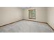 Bedroom with carpet floors and a window with blinds; natural light filtering through the window at 5822 Country Lane Dr, Durham, NC 27705