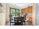 Bright dining area with wood cabinets and large window overlooking the deck at 5822 Country Lane Dr, Durham, NC 27705