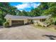 Lovely exterior view of home featuring an attached two-car garage, brick facade, and mature landscaping at 5822 Country Lane Dr, Durham, NC 27705