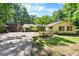 Exterior of beautiful home with large, landscaped front yard, mature shade tree, and two-car garage at 5822 Country Lane Dr, Durham, NC 27705