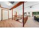 Bright foyer with light wood flooring, wooden railing, and large front door leading to an open living area with ample natural light at 5822 Country Lane Dr, Durham, NC 27705