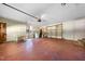 Large garage with a roll up door, concrete floor, shelving, and space for storage at 5822 Country Lane Dr, Durham, NC 27705