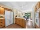 Open-concept kitchen featuring wood cabinets and stainless steel appliances at 5822 Country Lane Dr, Durham, NC 27705