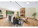 A well-decorated living room showcases a brick fireplace, neutral-toned furniture, and a large window with backyard views at 5822 Country Lane Dr, Durham, NC 27705