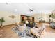 Bright living area with an open floor plan featuring wood flooring, modern décor, and seamless access to the dining space at 5822 Country Lane Dr, Durham, NC 27705