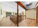 Open-concept living room with wood floors, a brick fireplace, and a sliding glass door with access to an outdoor deck at 5822 Country Lane Dr, Durham, NC 27705