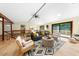 Inviting living room with stylish furnishings, wood floors, and sliding doors that provide deck access and views of nature at 5822 Country Lane Dr, Durham, NC 27705