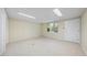 Versatile room with a bright window, neutral flooring and an entry door, offering flexible space at 5822 Country Lane Dr, Durham, NC 27705