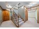 Carpeted staircase with wood railings, leading to the upper level of the home at 5822 Country Lane Dr, Durham, NC 27705