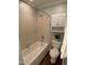 A clean bathroom features a standard tiled tub and shower combination with a storage cabinet above the toilet at 600 Audobon Lake Dr # One B21, Durham, NC 27713