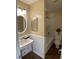 Well-lit bathroom features a sink with wall mirror and a tub and shower combo with a toilet at 600 Audobon Lake Dr # One B21, Durham, NC 27713