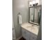 Neutral toned bathroom with a sink with white vanity and a decorative wall mirror at 600 Audobon Lake Dr # One B21, Durham, NC 27713