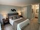 Bedroom with queen bed, side tables and decorative wall art with carpet flooring at 600 Audobon Lake Dr # One B21, Durham, NC 27713