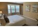 Bedroom features bay window with sitting area and queen bed with neutral toned bedding at 600 Audobon Lake Dr # One B21, Durham, NC 27713