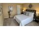 Bedroom features a queen bed, two side tables with lamps, and a decorative wall art at 600 Audobon Lake Dr # One B21, Durham, NC 27713