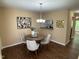 Cozy dining area with stylish lighting, modern art, and view to kitchen and living room at 600 Audobon Lake Dr # One B21, Durham, NC 27713