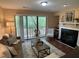 Comfortable living room boasting a fireplace, plush seating, and balcony access with scenic views at 600 Audobon Lake Dr # One B21, Durham, NC 27713