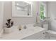 Bright bathroom with a modern vanity, white cabinets, and neutral paint at 6032 Epping Forest Dr, Raleigh, NC 27613