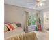 Bright bedroom with natural light, ceiling fan, and ensuite bathroom at 6032 Epping Forest Dr, Raleigh, NC 27613