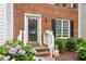 Charming front entrance with brick steps, decorative plants, and inviting doorway at 6032 Epping Forest Dr, Raleigh, NC 27613