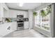 Bright kitchen with white cabinets and stainless steel appliances at 6032 Epping Forest Dr, Raleigh, NC 27613