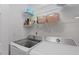 Functional laundry room with modern washer and dryer, plus shelving for storage at 6032 Epping Forest Dr, Raleigh, NC 27613