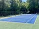 Outdoor tennis court in the community with a bench to relax and enjoy the surrounding scenery at 6032 Epping Forest Dr, Raleigh, NC 27613