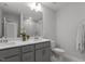 Bright bathroom with dual vanity, neutral finishes, and tiled shower featuring a rainfall showerhead at 604 Craftsman Ridge Trail Trl, Knightdale, NC 27545