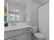 Neutral bathroom with white countertops and cabinets, a large mirror, and a shower with a curtain at 604 Craftsman Ridge Trail Trl, Knightdale, NC 27545