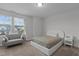 Bright bedroom features neutral walls, carpet, sofa, and a plush bed overlooking serene outdoor scenery at 604 Craftsman Ridge Trail Trl, Knightdale, NC 27545