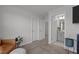 Bedroom with neutral walls and carpets, with an open door to a bathroom and a hallway to a closet at 604 Craftsman Ridge Trail Trl, Knightdale, NC 27545