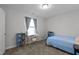 Inviting bedroom with a comfy bed, a window desk, and blue bookcases for a study space at 604 Craftsman Ridge Trail Trl, Knightdale, NC 27545