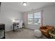 Bedroom with a workspace, a brown leather armchair, neutral walls and carpets, and large bright windows at 604 Craftsman Ridge Trail Trl, Knightdale, NC 27545