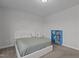 Cozy bedroom showcasing a bed, white walls, and a blue bookcase against neutral carpeting at 604 Craftsman Ridge Trail Trl, Knightdale, NC 27545