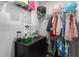 Functional walk-in closet with shelving, hanging rods, and black dresser to maximize organization at 604 Craftsman Ridge Trail Trl, Knightdale, NC 27545