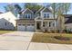 Charming two-story home with stone accents, a welcoming front porch, and a two-car garage at 604 Craftsman Ridge Trail Trl, Knightdale, NC 27545