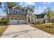 Charming two-story home with stone accents, a welcoming front porch, and a two-car garage at 604 Craftsman Ridge Trail Trl, Knightdale, NC 27545