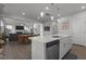 Open concept kitchen with an island, white cabinets, and views of the living room and dining area at 604 Craftsman Ridge Trail Trl, Knightdale, NC 27545